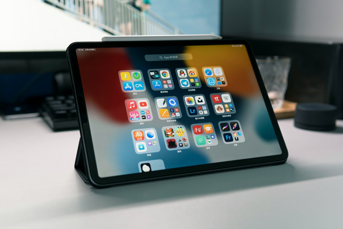 Reviews Tablet with colorful app icons rests on a white desk.